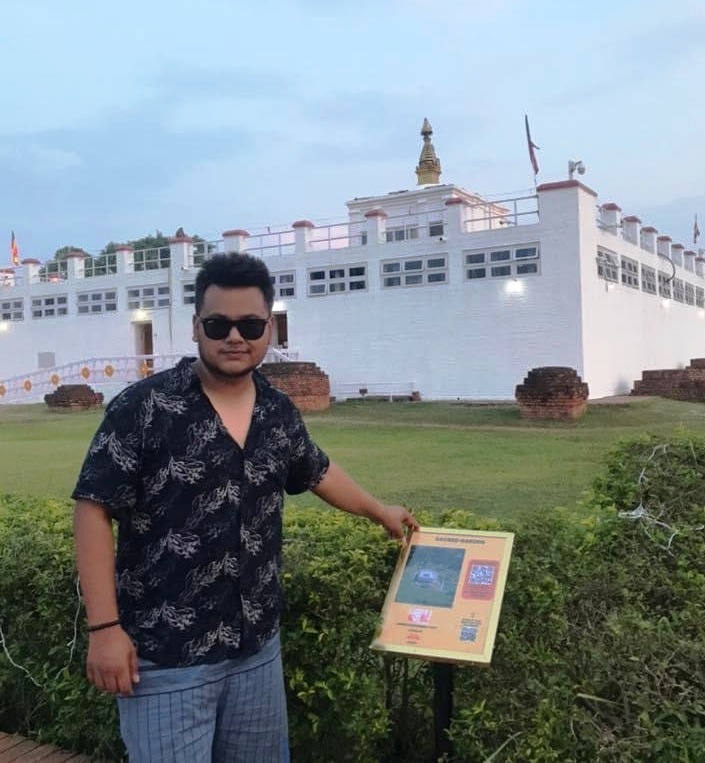 Sachin Dangi, founder/CEO at Saarang, standing next to a QR board in Lumbini